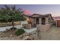 Charming single-story home featuring desert landscaping, a covered porch, and a two-car garage at 17938 W Cedarwood Ln, Goodyear, AZ 85338