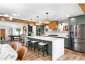 Spacious kitchen with seating at the large island, stainless steel appliances and wood accents at 1825 N Granite Reef Rd, Scottsdale, AZ 85257