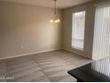Living area with plush carpeting, bright light fixtures, and slider door at 1920 E Bell Rd # 1188, Phoenix, AZ 85022