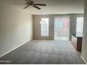 Spacious living room with carpet flooring, ceiling fan, and natural light at 1920 E Bell Rd # 1188, Phoenix, AZ 85022