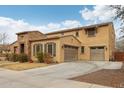 Charming two-story home featuring a stone facade, two-car garage, and well-maintained landscaping at 20916 E Via De Arboles --, Queen Creek, AZ 85142