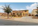 Charming two-story home featuring a stone facade, two-car garage, and well-maintained landscaping at 20916 E Via De Arboles --, Queen Creek, AZ 85142