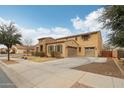 Charming two-story home featuring a stone facade, two-car garage, and well-maintained landscaping at 20916 E Via De Arboles --, Queen Creek, AZ 85142