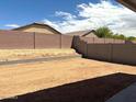 Spacious backyard with a block fence, offering privacy and potential for landscaping at 24578 W Grenadine Rd, Buckeye, AZ 85326