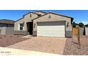 Charming single-story home with a two-car garage and desert landscaping at 24598 W Grenadine Rd, Buckeye, AZ 85326
