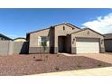 Charming single-story home with a two-car garage and desert landscaping at 24598 W Grenadine Rd, Buckeye, AZ 85326