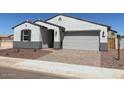 Inviting single-story home featuring a neutral color palette, a two-car garage, and desert landscaping at 24612 W Grenadine Rd, Buckeye, AZ 85326