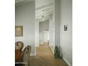 Bright hallway featuring hardwood floors and crisp white trim, leading to other rooms at 3140 E Claremont Ave, Phoenix, AZ 85016