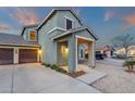 A two-story home with a two-car garage and inviting front porch, perfect for relaxing outdoors at 3360 E Joseph Way, Gilbert, AZ 85295