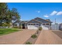 Charming single-Gathering home boasts a spacious driveway and a well-manicured front lawn on a bright day at 3401 N 34Th Pl, Phoenix, AZ 85018