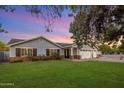 Charming single-Gathering home boasts beautiful landscaping and brick accents under a colorful sky at 3401 N 34Th Pl, Phoenix, AZ 85018
