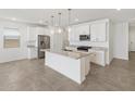 Open kitchen features an island, stainless steel appliances, and modern finishes at 3822 S 87Th Dr, Tolleson, AZ 85353