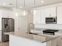 Bright kitchen with stainless steel appliances, granite countertops, and pendant lighting at 3822 S 87Th Dr, Tolleson, AZ 85353