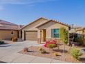 Beautiful home exterior featuring a desert landscaped yard, a two-car garage, and a welcoming front entrance at 3948 W Kirkland Ave, Queen Creek, AZ 85142