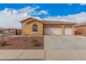 Inviting single-Gathering home featuring a three-car garage and desert landscaping in front yard at 5108 N 191St Dr, Litchfield Park, AZ 85340