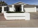 Attractive single-Gathering home with a neat front garden and a classic white facade at 518 W Beverly Ln, Phoenix, AZ 85023