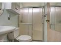 Cozy bathroom features a toilet and shower with sliding glass doors, along with a sink and vanity area at 7750 E Broadway Rd # 225, Mesa, AZ 85208