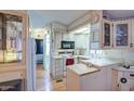 Cozy kitchen with white cabinetry, wood-style floors, and lots of natural light and plenty of counter space at 7750 E Broadway Rd # 225, Mesa, AZ 85208
