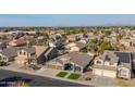 An elevated neighborhood view with single-Gathering homes, palm trees, and desert landscape at 9654 E Pantera Ave, Mesa, AZ 85212