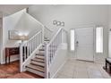 Inviting foyer with staircase and tile flooring at 10022 W Luxton Ln, Tolleson, AZ 85353