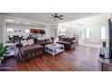 Open-concept living room showcases hardwood floors and seamless flow to the kitchen at 10022 W Luxton Ln, Tolleson, AZ 85353