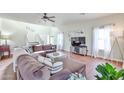 Bright living room boasts hardwood floors, vaulted ceilings, and ample seating at 10022 W Luxton Ln, Tolleson, AZ 85353