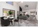 Open-concept dining and living area with vaulted ceilings, large windows, and contemporary decor at 10056 E San Bernardo Dr, Scottsdale, AZ 85258