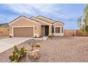 Single-story home featuring desert landscape, neutral tones, and a two car garage at 10545 W Mission Dr, Arizona City, AZ 85123