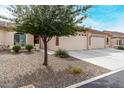 Cozy one-story home featuring a well-kept desert front yard and a two-car garage at 10960 E Monte Ave # 257, Mesa, AZ 85209