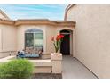 Inviting front porch with potted plants, a cozy bench, and a welcoming entrance at 10960 E Monte Ave # 257, Mesa, AZ 85209