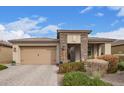 Charming single-story home featuring desert landscaping, stone accents, and a two-car garage at 11558 W Levi Dr, Avondale, AZ 85323