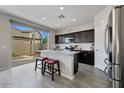 Well-equipped kitchen with stainless steel appliances and a breakfast bar overlooking the backyard at 12018 W Taylor St, Avondale, AZ 85323