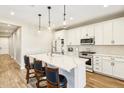Modern kitchen featuring a center island with quartz countertops, pendant lighting, and stainless steel appliances at 13218 W Crimson Ter, Peoria, AZ 85383