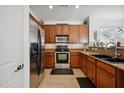 Well-lit kitchen with stainless steel appliances, wooden cabinets, and granite countertops at 1347 S Sabino Dr, Gilbert, AZ 85296