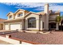 Attractive two-story home boasting a three-car garage and well-kept desert landscaping at 1478 E Spur Ave, Gilbert, AZ 85296