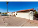 Lovely single-story home showcasing a well-maintained driveway and red tile roofing at 1500 N Markdale -- # 8, Mesa, AZ 85201