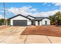 Beautiful home featuring a modern gray and white exterior, complemented by a well-manicured, low maintenance landscape at 16422 S 45Th Pl, Phoenix, AZ 85048