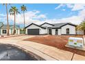 Welcoming home with a modern facade, featuring desert landscaping, neutral paint, and a spacious two-car garage at 16422 S 45Th Pl, Phoenix, AZ 85048