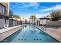 Community pool with hot tub, sun loungers and palm trees, offering a resort-style experience for residents at 1717 E Morten Ave # 2, Phoenix, AZ 85020