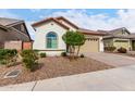 Landscaped front yard of a charming single-story home with a brick driveway and low-maintenance desert landscaping at 23150 E Thornton Rd, Queen Creek, AZ 85142