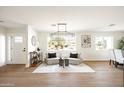 Bright sitting room featuring contemporary furniture, decor and hardwood floors at 3141 E Hillery Dr, Phoenix, AZ 85032
