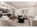 Bright living room featuring stylish furniture, decorative rug, and an open floor plan at 3229 E Malapai Dr, Phoenix, AZ 85028