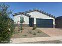 Charming single-story home with a two-car garage and desert landscaping in front at 3732 S 87Th Dr, Tolleson, AZ 85353