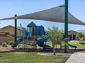 Community playground with colorful play structures, shade canopy, and green grass for Gathering fun at 3814 S 87Th Dr, Tolleson, AZ 85353