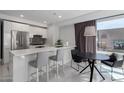 Contemporary kitchen with stainless steel appliances, white cabinets, and breakfast bar seating at 4422 N 75Th St # 6007, Scottsdale, AZ 85251