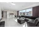 Open-concept living space with sofa, ottoman, and floor-to-ceiling windows blending seamlessly with the kitchen at 4422 N 75Th St # 6007, Scottsdale, AZ 85251