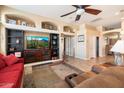 Spacious living room with built-in shelving, a ceiling fan, and comfortable seating area at 5932 W Poinsettia Dr, Glendale, AZ 85304