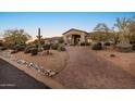 Paver driveway leading to a well-manicured property with mature landscaping and desert charm at 6240 E Ironwood Dr, Scottsdale, AZ 85266