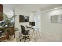 The bright office space features tiled floors and glass desk with adjacent kitchen area at 7161 E Rancho Vista Dr # 6002, Scottsdale, AZ 85251