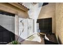 A protected front entry features decorative ironwork and a desert themed welcome mat at 13642 S 42Nd St, Phoenix, AZ 85044